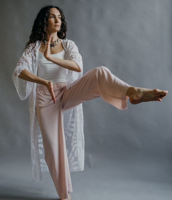 Person practicing gentle yoga movements in a peaceful environment